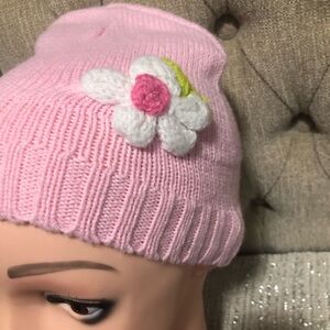 Small Pink child’s hat with big flower. Could fit baby toddler, or a young girl.